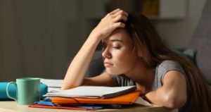 Student puts hand on head in despair of turning in late homework