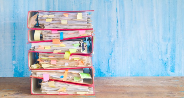 Stack of books and place holders for research paper