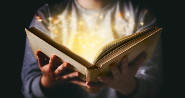 Book is opened with light and stars emerging from book