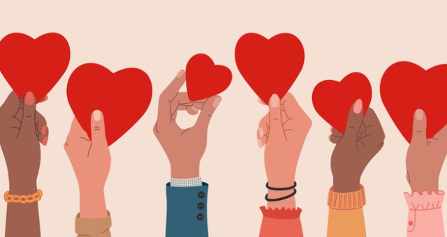 Human hands holding cut-out hearts