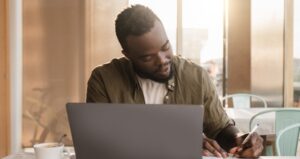 An adult learner using laptop to attend class