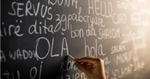 Hello written in numerous languages on the chalkboard