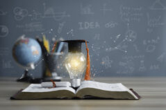 Graduation cap with a lightbulb on the book and globe in the classroom. Education learning concepts in school or university. Idea knowledge of innovative technology, science, and mathematics.