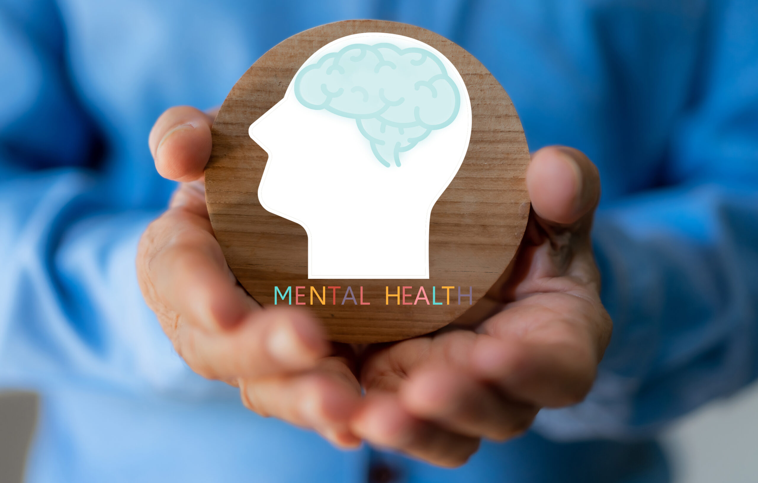 Mental health awareness, human hand care and support hold white paper head and glowing brain with physical and mental health, wellbeing, brain health, psychological support, healthcare and mindfulness