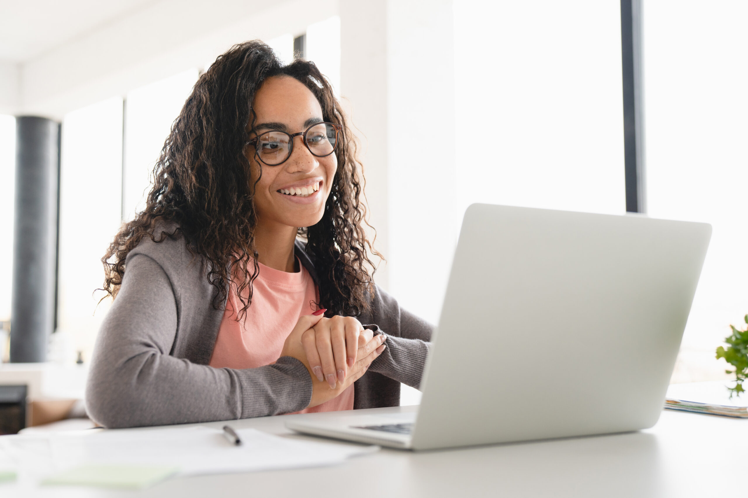 Happy young african student in online higher education class
