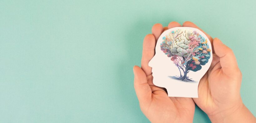 Hands holding silhouette of head with colorful plant growing. health and wellness. self-care.