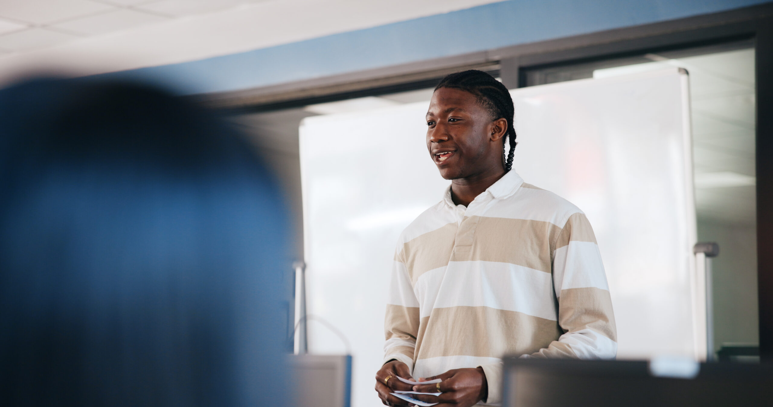 Black man, student and presentation with whiteboard for learning, moderation or education at university. African learner, assessment or introduction with notes or cue cards for oral exam at college