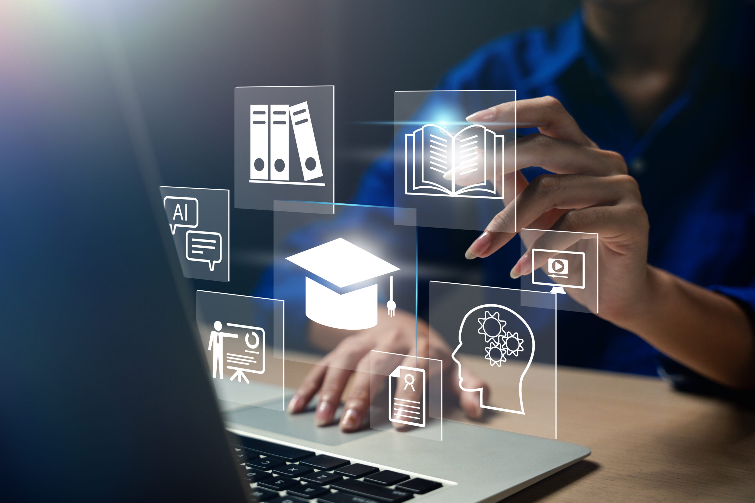 Focus on a hand selecting an icon on a digital screen that showcases various educational symbols like books, graduation caps, and AI, illustrating the concept of online courses, e-learning, and modern educational technology. Course design.